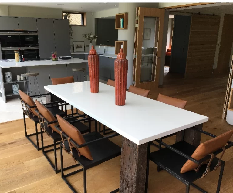 Big white modern table inside a huge house in London. Fresh interior in the luxury kitchen.