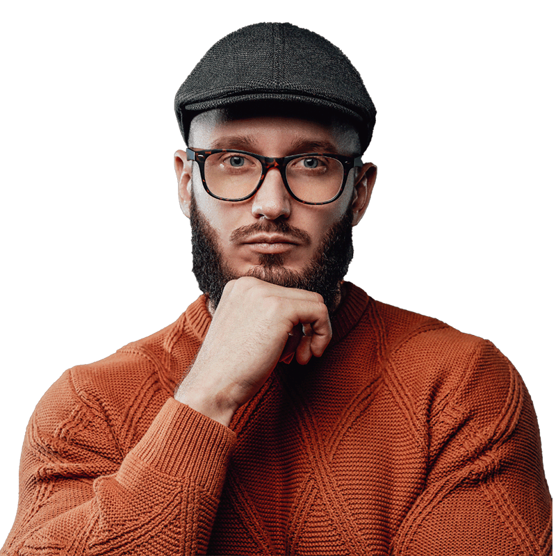 Relocation to London specialist, stylish man with a beard in an orange jumper, wearing glasses, and a hat.